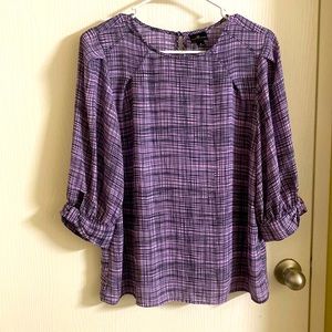 Stylish purple top in small size., with a cute sleeve cutout